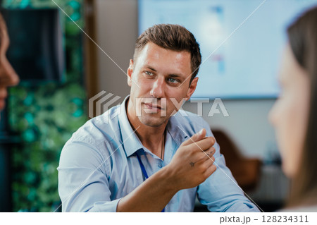 Young businessman eating healthy salad lunch with colleagues in modern office cafeteria Young businessman eating healthy salad lunch with colleagues in modern office cafeteria 128234311