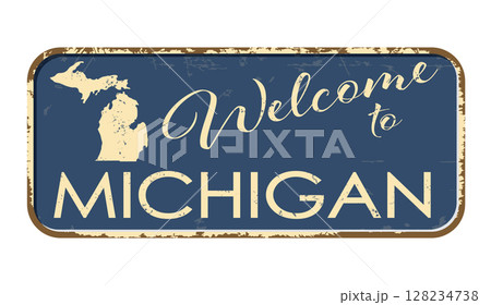 Welcome to Michigan. A worn blue plaque with the name and outline of the state. Welcome inscription on the road sign 128234738