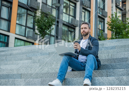 freelance man with laptop outdoor, banner. freelance man in the street. freelance man with laptop outdoor, banner. freelance man in the street. 128235215