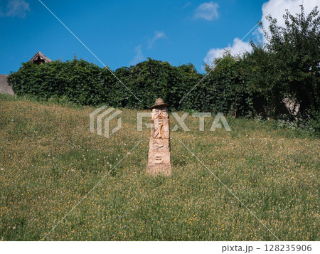 Exploring pagan culture in Opishnia, Poltava region of Ukraine with stone sculptures in a lush Exploring pagan culture in Opishnia, Poltava region of Ukraine with stone sculptures in a lush 128235906