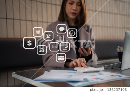 Business woman calculates financials with graph paper on the table on the cost. Business woman calculates financials with graph paper on the table on the cost. 128237108