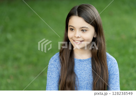 Trendy stylish teenager girl smiling. Fall fashion style for teen. Complete outfit style. Girl portrait in casual sweater. Long brunette hair. Teen girl with long hair outdoor. Autumn fashion girl 128238549