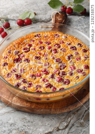Summer cherry clafoutis pie with fresh berries close-up in baking dish. Vertical 128238875