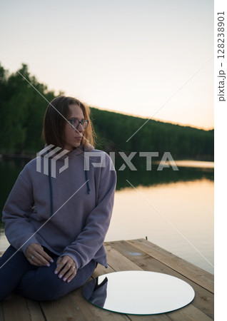 Woman on the pier at lake Woman on the pier at lake 128238901