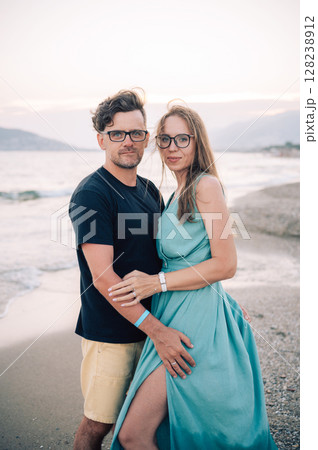 Happy Couple Embracing on a Sandy Beach 128238912