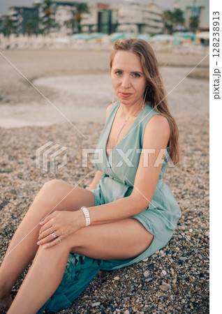 Woman in Flowing Dress on Seaside Pier Woman in Flowing Dress on Seaside Pier 128238913