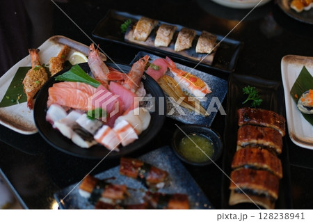 Eel fish sushi, sashimi Nigiri Platter, japanese sushi restaurant, Fresh Tuna and Salmon Slices in modern cafe, traditional food, raw red fish dish, omega 3. 128238941