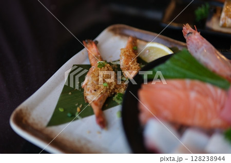 Sushi Set nigiri and sushi rolls with tea served on gray stone slate on metal background 128238944