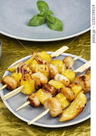 Fried scallops with pineapple on plate. 128239814