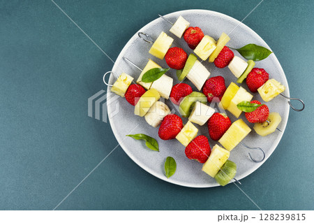 Fruit on skewer, appetizers mini snacks. Fruit on skewer, appetizers mini snacks. 128239815