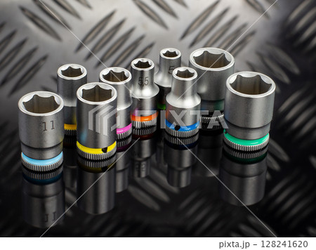 Set of Color Coded Socket Wrenches on Black Surface 128241620