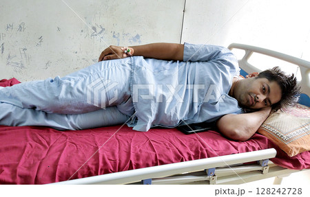 Patient Resting in Hospital Bed Post Surgery in Medical Ward Patient Resting in Hospital Bed Post Surgery in Medical Ward 128242728