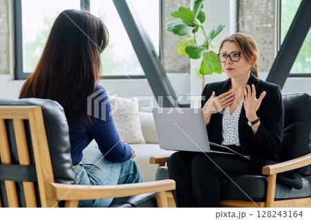 Female mental health professional working with young woman Female mental health professional working with young woman 128243164