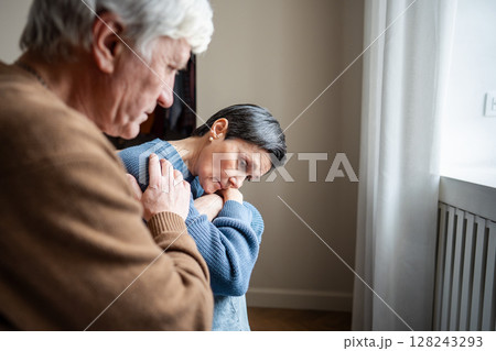 Depressed wife and consoling husband. Deep sadness follow tragedy, solace from senior husband 128243293