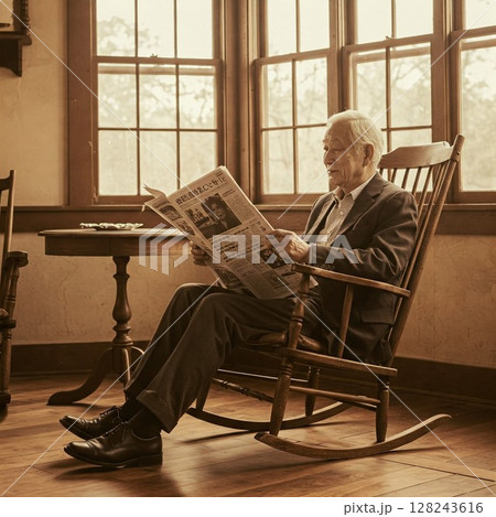 ロッキングチェアで新聞を読むシニア男性の写真｜穏やかな日常、読書、老後、くつろぎの休日 128243616