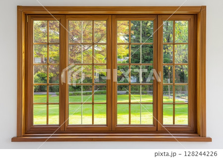 New wooden PVC window with brown metal frame installed at modern house, view of blurred green trees, blue sky. Advertising. Typical installation of insulated glazing windows with uPVC window frames. 128244226