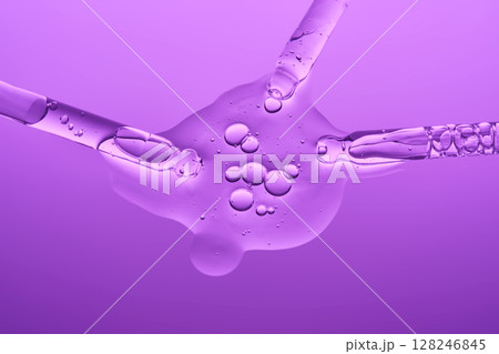 Cosmetic gel or serum on a lilac background with three pipettes. Cosmetic gel or serum on a lilac background with three pipettes. 128246845