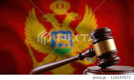 Close-up of judge's gavel with Montenegro flag behind 128247073