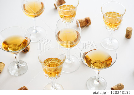 Set of glasses of yellow wine at wine tasting 128248153