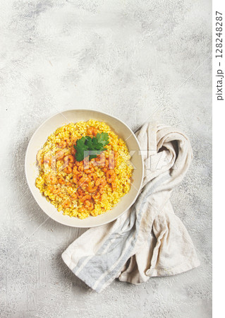 risotto with shrimp, in a bowl, on a textured surface, with a side dish of fresh coriander, homemade, no people, risotto with shrimp, in a bowl, on a textured surface, with a side dish of fresh coriander, homemade, no people, 128248287