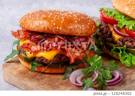 two burgers with beef patty, fried bacon, cheddar cheese, tomatoes, homemade, no people, two burgers with beef patty, fried bacon, cheddar cheese, tomatoes, homemade, no people, 128248302