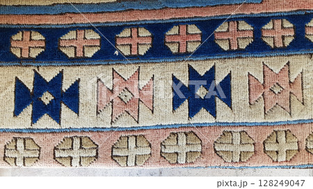 Soft texture of traditional Turkish ethnic patterned carpet closeup 128249047