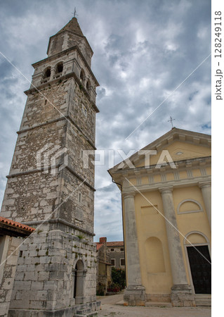 Historic bell tower and church with dramatic sky. Visnjan, Croatia. 128249118