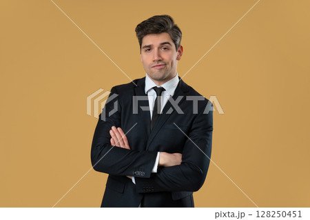 Confident arrogant businessman posing with smug expression and crossed arms 128250451