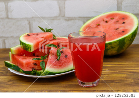 Glass of fresh watermelon juice on a wooden table Glass of fresh watermelon juice on a wooden table 128252383