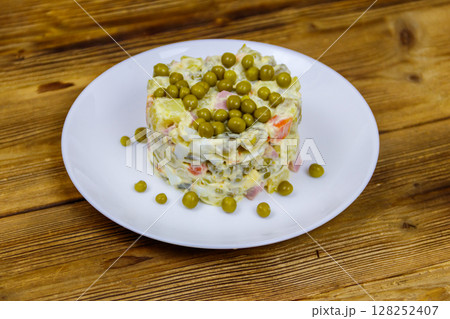 Traditional Russian festive salad Olivier on wooden table Traditional Russian festive salad Olivier on wooden table 128252407