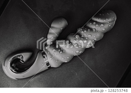 Silicone vibrator in water. Circles on water around sex toy. Silicone vibrator in water. Circles on water around sex toy. 128253748