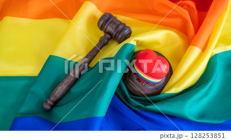 Judge's gavel and heart on rainbow flag. Judge's gavel and heart on rainbow flag. 128253851