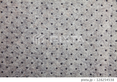 Grey felt material background with dark dots Grey felt material background with dark dots 128254538