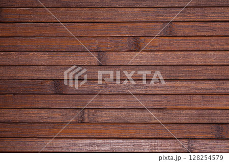 Dark brown wooden planks background with copyspace 128254579