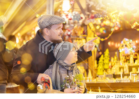 Father and son choose figures for the nativity scene 128254660