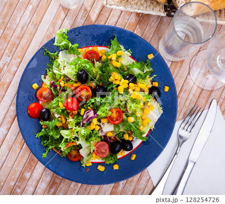 Salad with lettuce, tomato, corn and olives Salad with lettuce, tomato, corn and olives 128254726