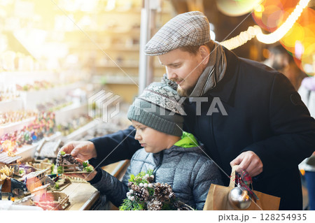 Father and son choose figures for the nativity scene Father and son choose figures for the nativity scene 128254935