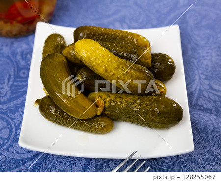 Pile of pickled cucumbers served on table Pile of pickled cucumbers served on table 128255067
