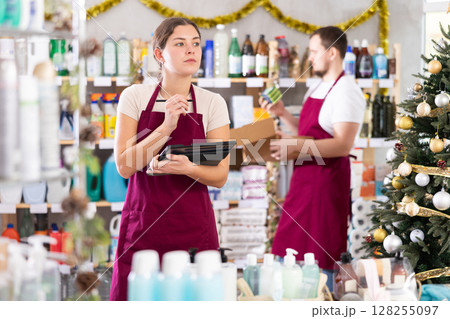 Female household goods store worker using tablet to manage inventory Female household goods store worker using tablet to manage inventory 128255097