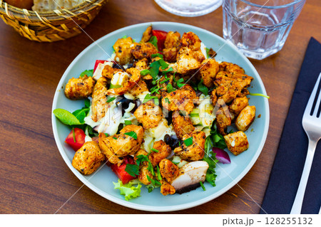 Traditional dish of American cuisine is a warm Caesar salad with fried chicken and champignons 128255132