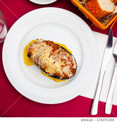 Eggplant stuffed with baked vegetables in sauce and baked cheese Eggplant stuffed with baked vegetables in sauce and baked cheese 128255288
