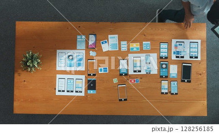 Top view of software developer holding tablet while choosing icon. Convocation. 128256185