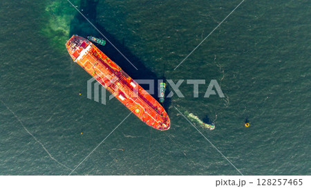 Aerial view oil ship tanker vessel loading and unloading in oil terminal station refinery, Global business import export logistic transport sea freight cargo tanker, Red crude oil tanker ship at port. 128257465