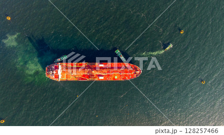 Aerial view oil ship tanker vessel loading and unloading in oil terminal station refinery, Global business import export logistic transport sea freight cargo tanker, Red crude oil tanker ship at port. 128257466