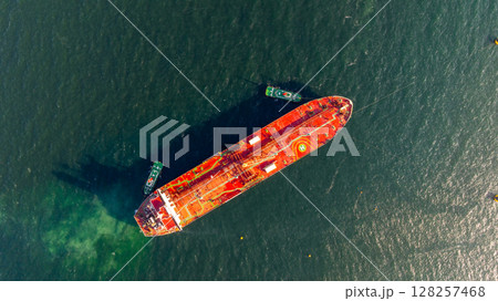 Aerial view oil ship tanker vessel loading and unloading in oil terminal station refinery, Global business import export logistic transport sea freight cargo tanker, Red crude oil tanker ship at port. Aerial view oil ship tanker vessel loading and unloading in oil terminal station refinery, Global business import export logistic transport sea freight cargo tanker, Red crude oil tanker ship at port. 128257468