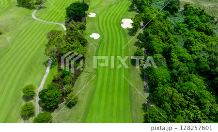 Aerial top view golf course with lush greens, green fairway and sand bunker, Golf course green grass and trees fairway and putting green, Beautiful golf course. 128257601