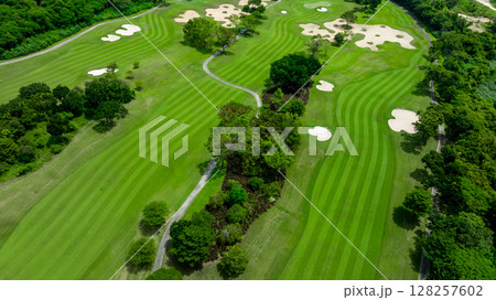 Aerial top view golf course with lush greens, green fairway and sand bunker, Golf course green grass and trees fairway and putting green, Beautiful golf course. 128257602