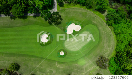Aerial top view golf course with lush greens, green fairway and sand bunker, Golf course green grass and trees fairway and putting green, Beautiful golf course. Aerial top view golf course with lush greens, green fairway and sand bunker, Golf course green grass and trees fairway and putting green, Beautiful golf course. 128257603