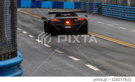 Motion blur race car racing on speed track, Motion blurred super car race on street track circuit, Automobile automotive transportation vehicle background, 128257622