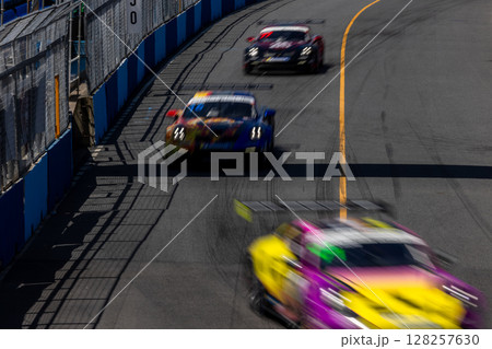 Motion blur race car racing on speed track, Motion blurred super car race on street track circuit, Automobile automotive transportation vehicle background, 128257630